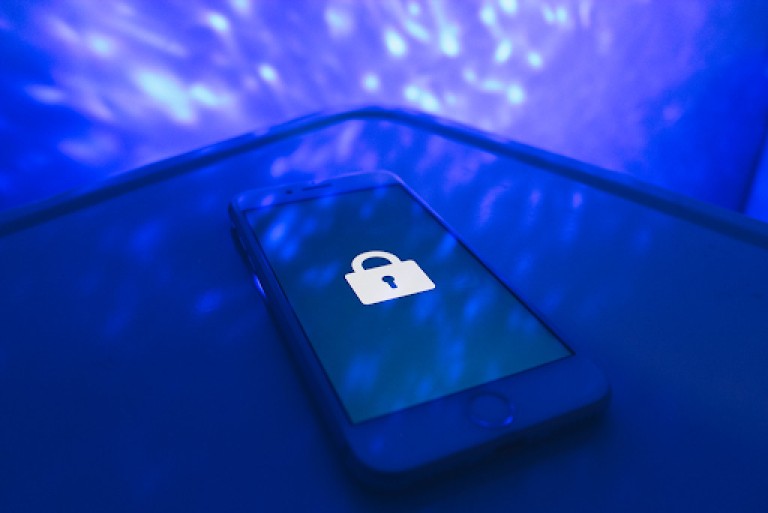 Image of a cellphone with a lock displaying on its screen.