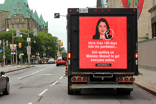 Truck with billboard: More than 180 days into the pandemic... Still waiting on Minister Monsef to get everyone online.